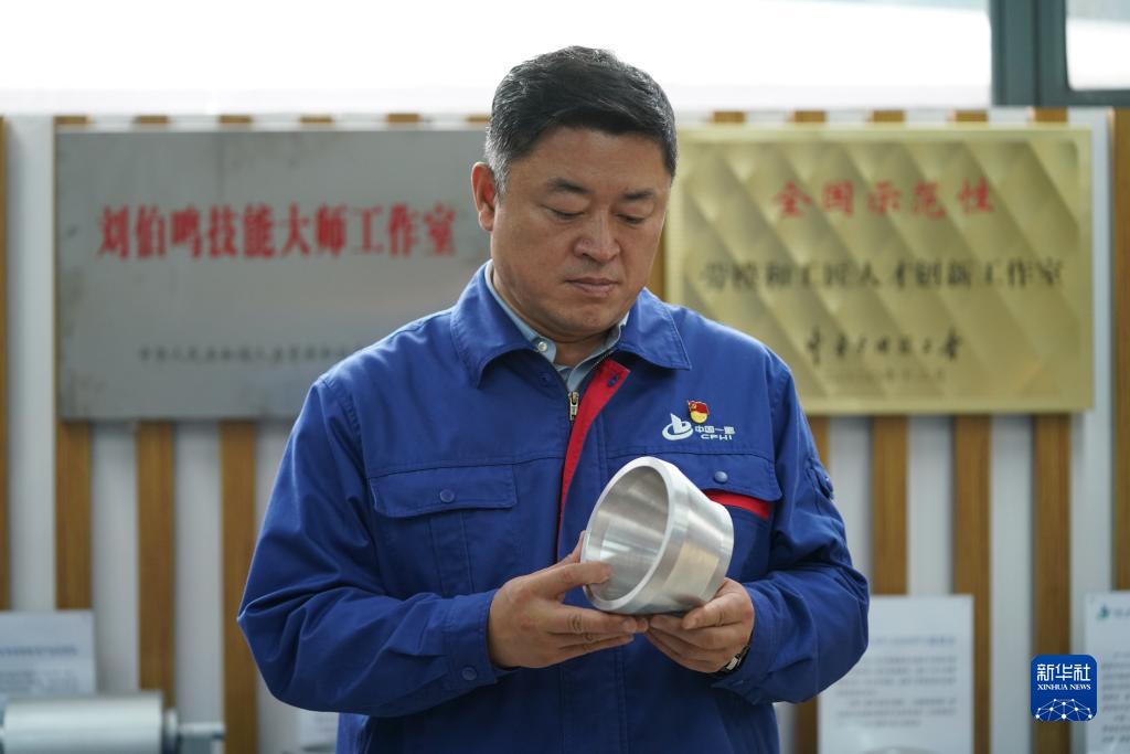 刘伯鸣在工作室内查看创新产品模型(2022年9月17日摄)。
